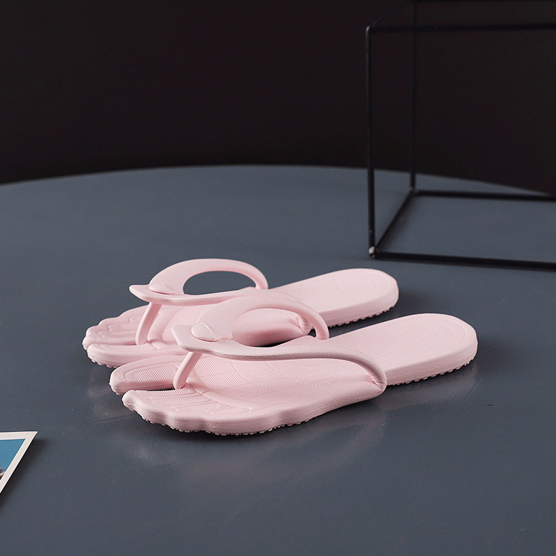 White folding flip flops opened flat on a slate blue round table