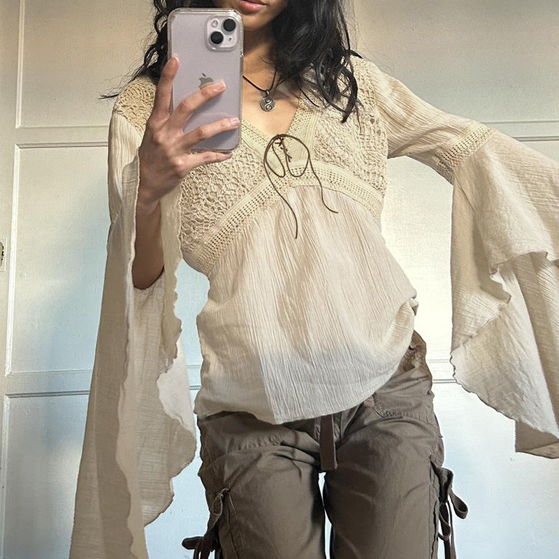 Mirror photo of the blouse worn loose, showing how light reads through the crinkle fabric of the sleeves