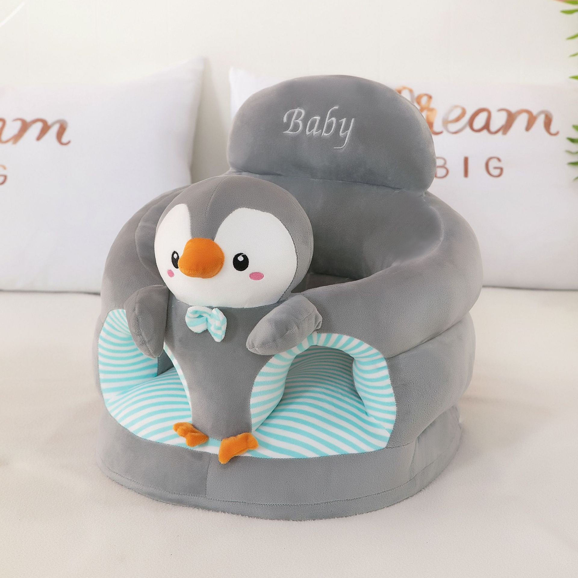 Red plush baby floor seat with a panda at the front and a soft padded seating ring