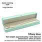 Open tiffany blue crown clasp necklace box with a pearl necklace on the grey padded lining