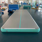 Mint green inflatable air track mat laid flat with a gray top, a center stripe and a round side valve