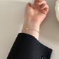 Heart bracelet worn on the wrist during a daily moment, paired with a soft cuff