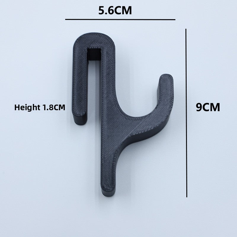 Black resin single hook with size marks, 5.6 cm wide and 9 cm tall, seen from the front on a light background