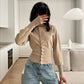 White rib knit cardigan shown on a model with long tapered sleeves