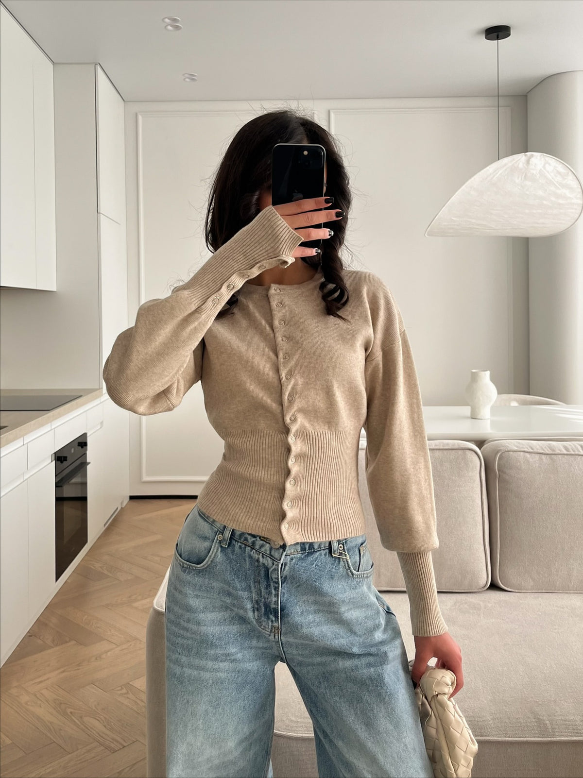 White rib knit cardigan shown on a model with long tapered sleeves