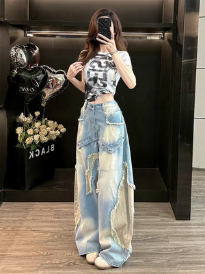 Light washed blue wide leg baggy jeans with frayed patch appliques worn by a woman, full length front view