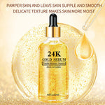 24K gold hyaluronic acid face serum in a glass dropper bottle beside a golden drop and suspended gold flecks
