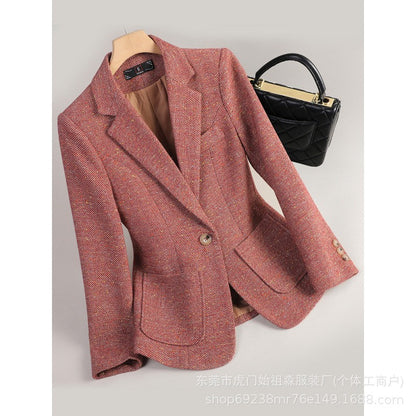 Orange red herringbone tweed blazer on a hanger, front view with notch lapel, one button and two patch pockets