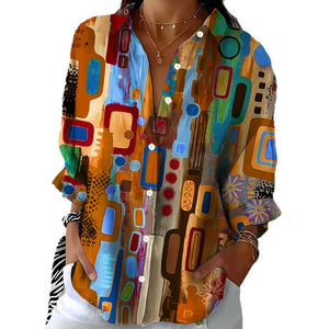 Long sleeve shirt in a colourful abstract painted print worn over white trousers, front view
