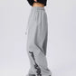 Side view of loose wide leg dance pants showing the streetwear graphic down one leg