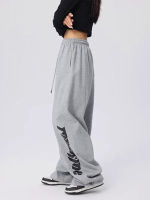 Side view of loose wide leg dance pants showing the streetwear graphic down one leg