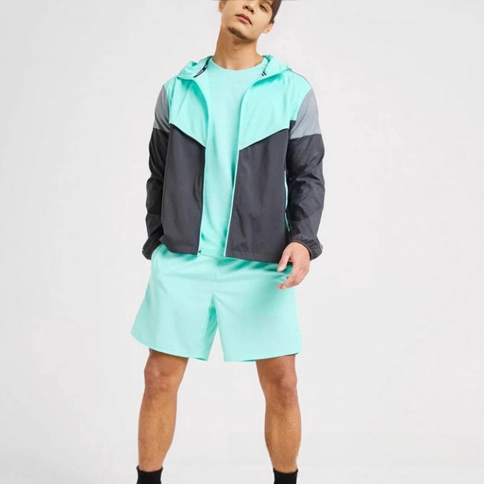 Pink and grey colour block sports jacket showing the hood and long sleeves on a model