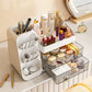 White cosmetic organizer with a brush tower and an open smoked transparent drawer holding creams and compacts
