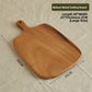 Walnut serving board with a hang handle shown holding bread and cheese