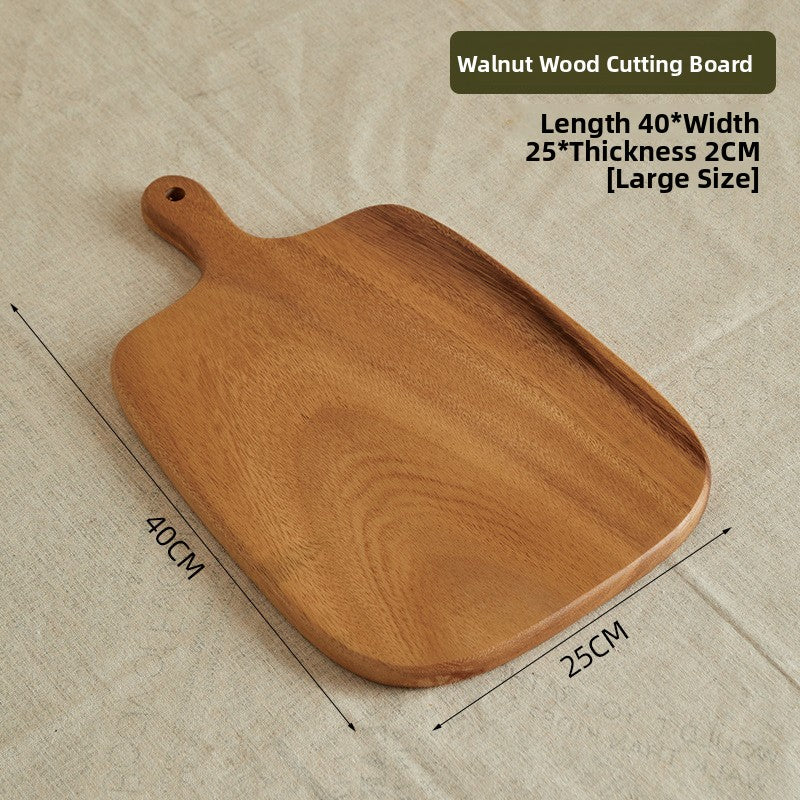 Walnut serving board with a hang handle shown holding bread and cheese