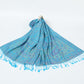 Azure blue paisley shawl with matching blue tassels spread on a white background