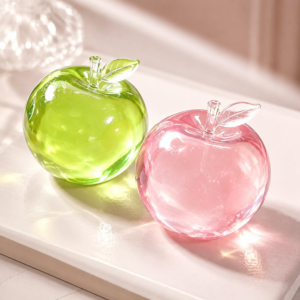 Translucent apple shaped squishy squeeze toy held and pressed between a finger and thumb
