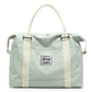 Mint green nylon weekender bag with cream handles