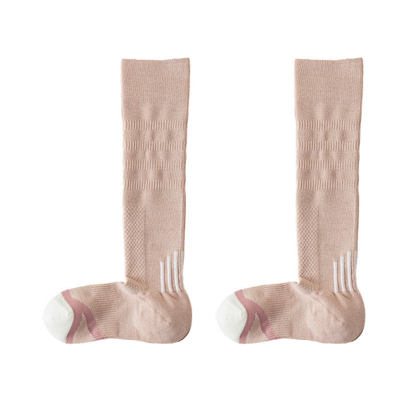 Pair of pink high tube compression socks with a ribbed leg, white toe and pink heel on a white background