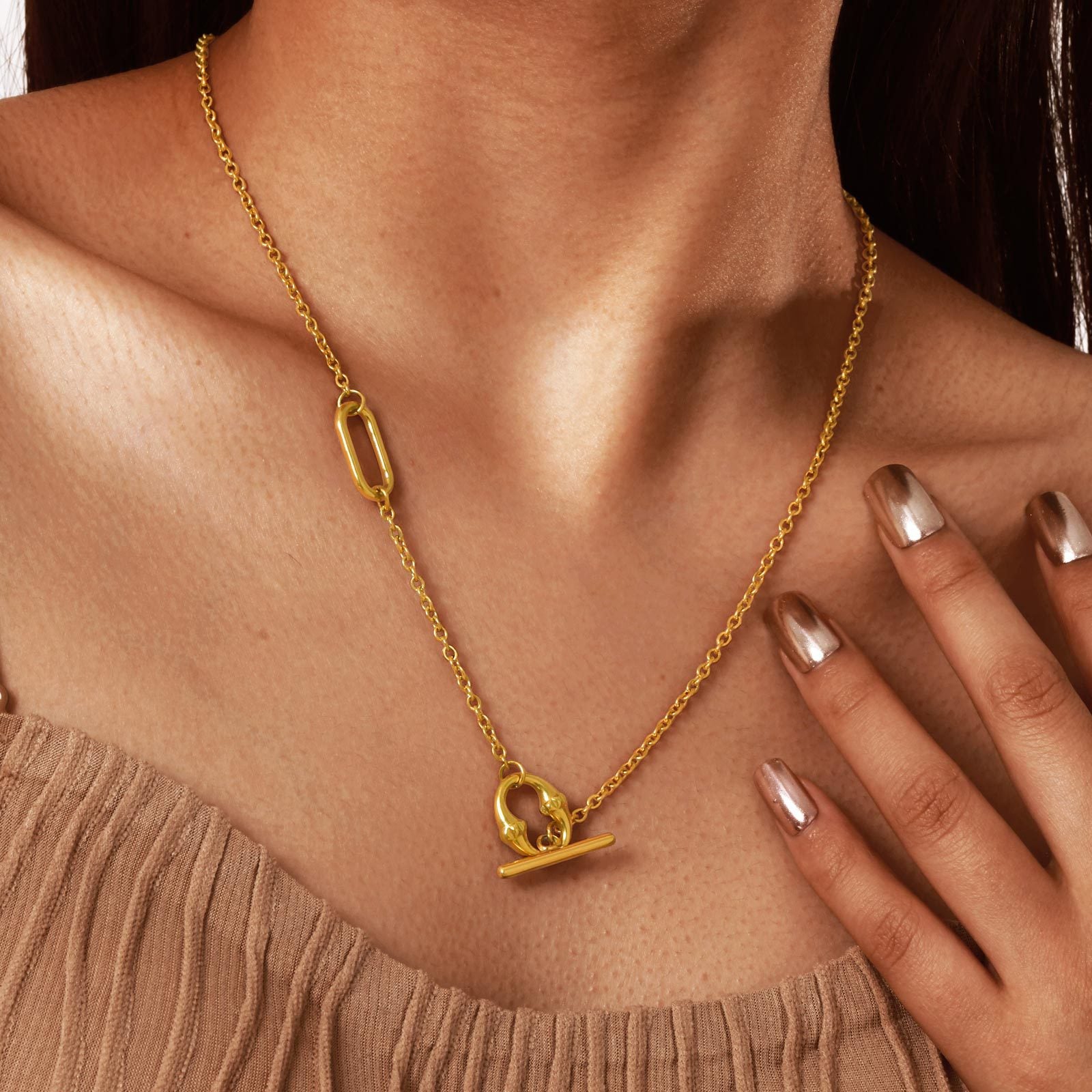 Side profile of the gold tone lariat necklace showing the thin chain and paperclip link