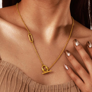 Side profile of the gold tone lariat necklace showing the thin chain and paperclip link
