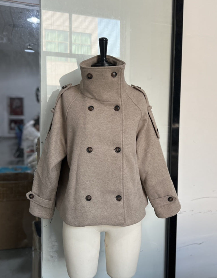 Detail of the buttoned cuff tab and sleeve on the taupe wool blend coat