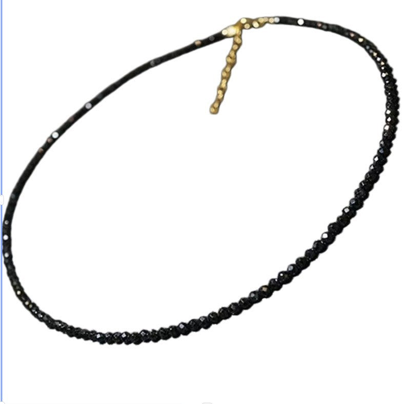 Clear faceted glass bead choker necklace with a gold tone lobster clasp