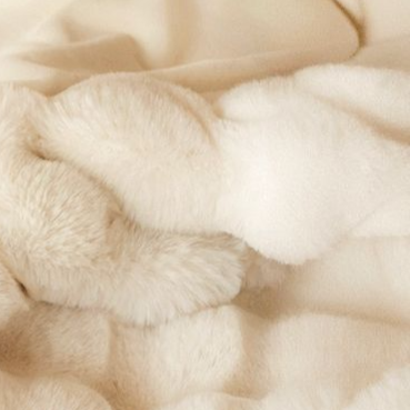 Plush throw blanket folded to show its double sided soft pile, studio shot