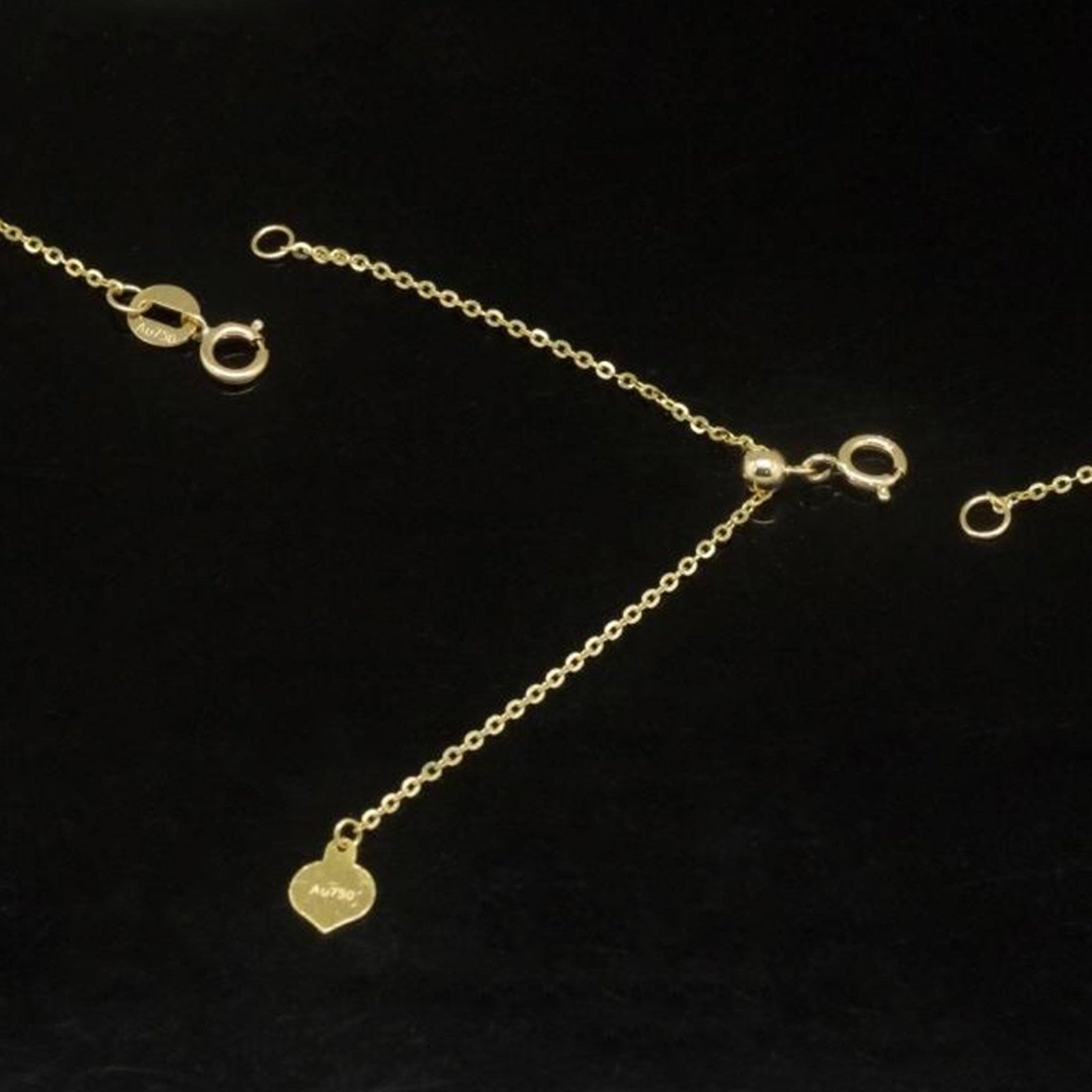 Gold extension chain clipped onto a necklace clasp in use