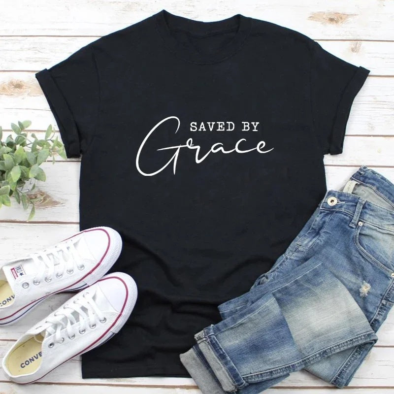 Women's cotton tee printed with the Saved by Grace faith slogan in script and block capitals