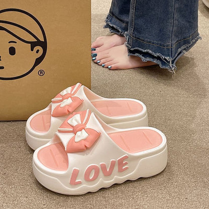 Womens platform slides, four colors of the platform slides on a wood floor