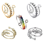 Set of adjustable spinner bead rings in gold tone, silver tone, and mixed color bead finishes on white