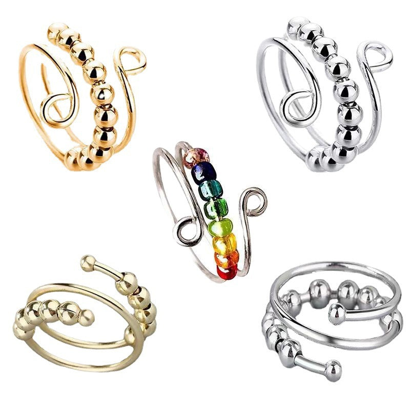Set of adjustable spinner bead rings in gold tone, silver tone, and mixed color bead finishes on white
