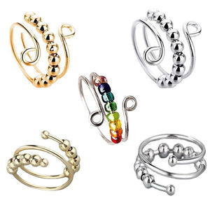 Set of adjustable spinner bead rings in gold tone, silver tone, and mixed color bead finishes on white