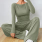 Sage green fitted long sleeve top and wide leg trousers matching set, seated studio pose