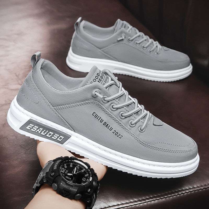 Gray canvas low-top lace-up sneakers with white sole on a leather sofa, size 44 option photo