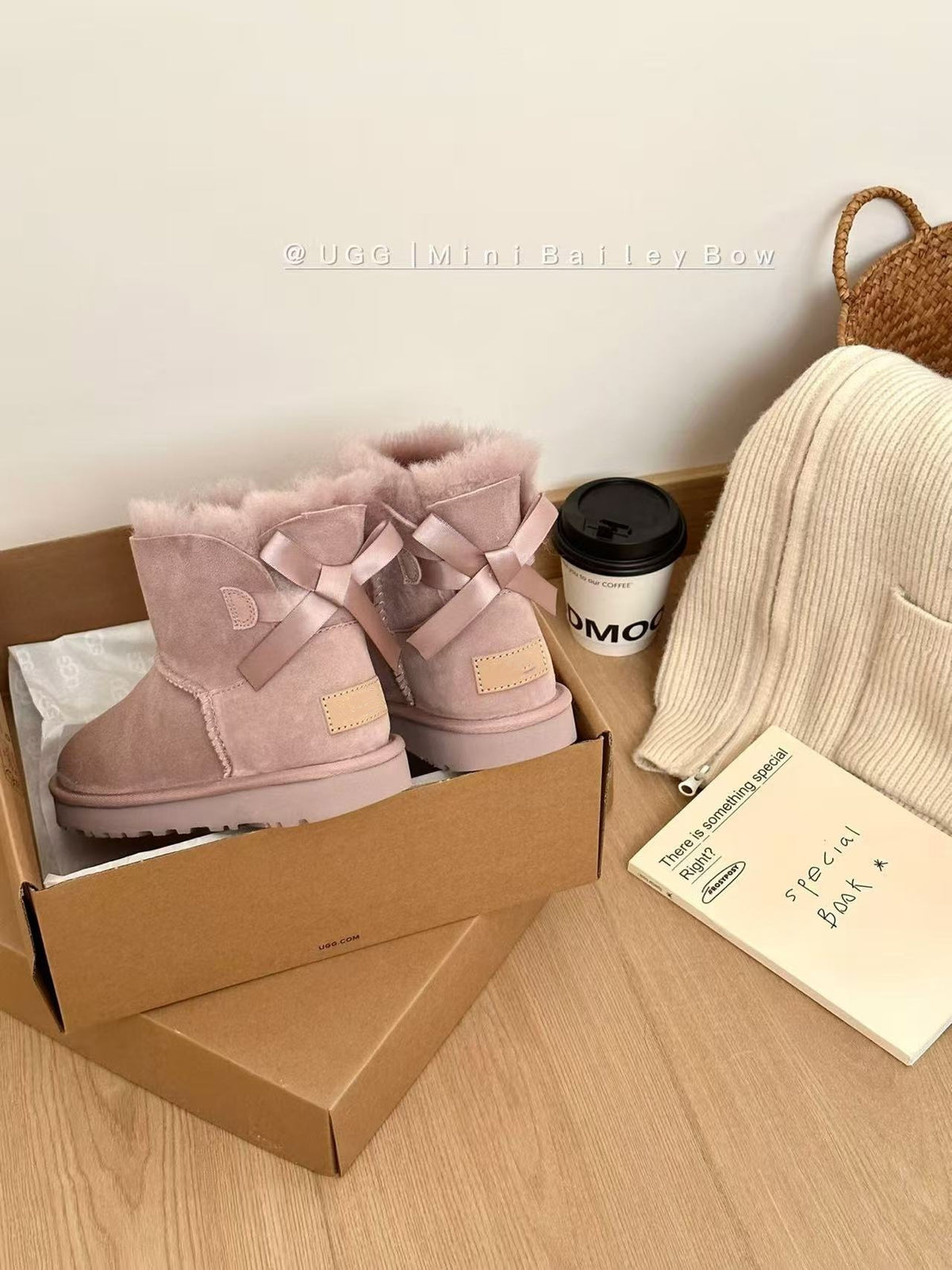 Pink suede ankle boots with satin ribbon bows in a cardboard box beside a knit scarf, Pink Thin Sole option, size 39