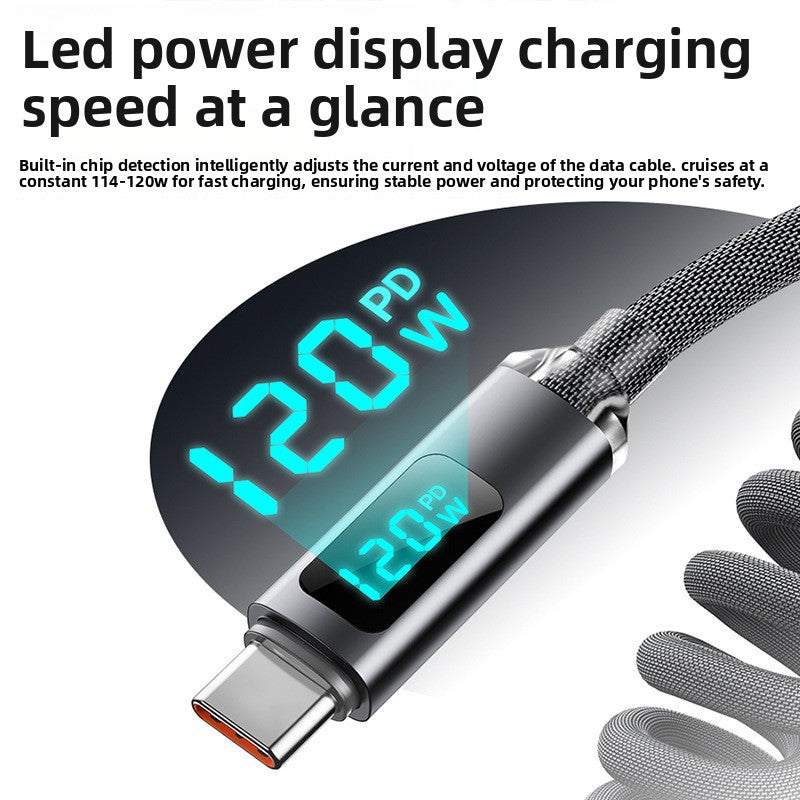 Macro of the connector LED screen reading 120W PD while the braided coiled cable charges