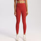 Women's high-rise yoga leggings with a wide waistband, worn on a plain studio backdrop