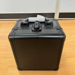 Black aluminium card storage case with folding carry handle and front latch, side view