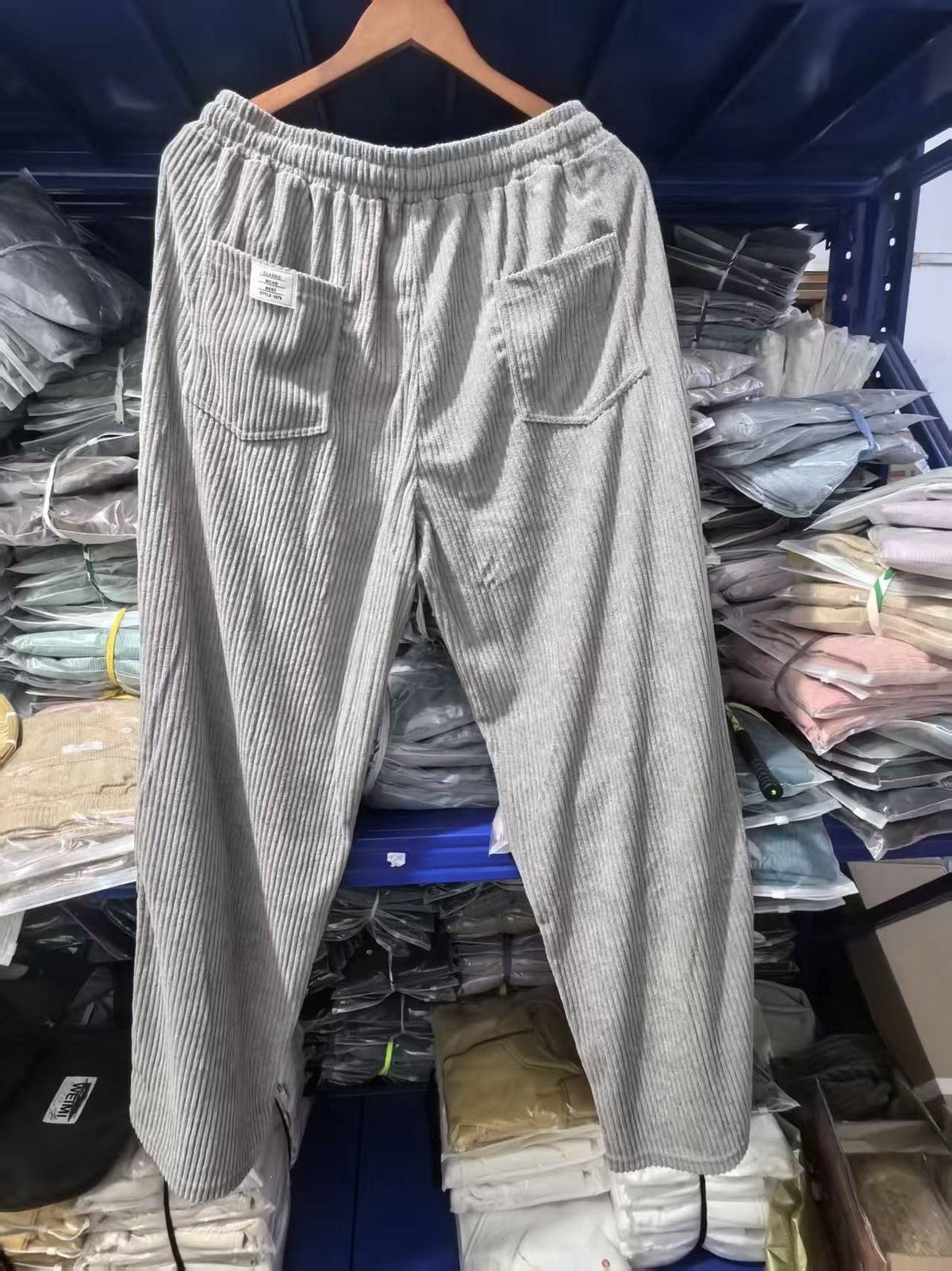 Back view of the wide wale corduroy trousers showing patch pockets and a woven flag label