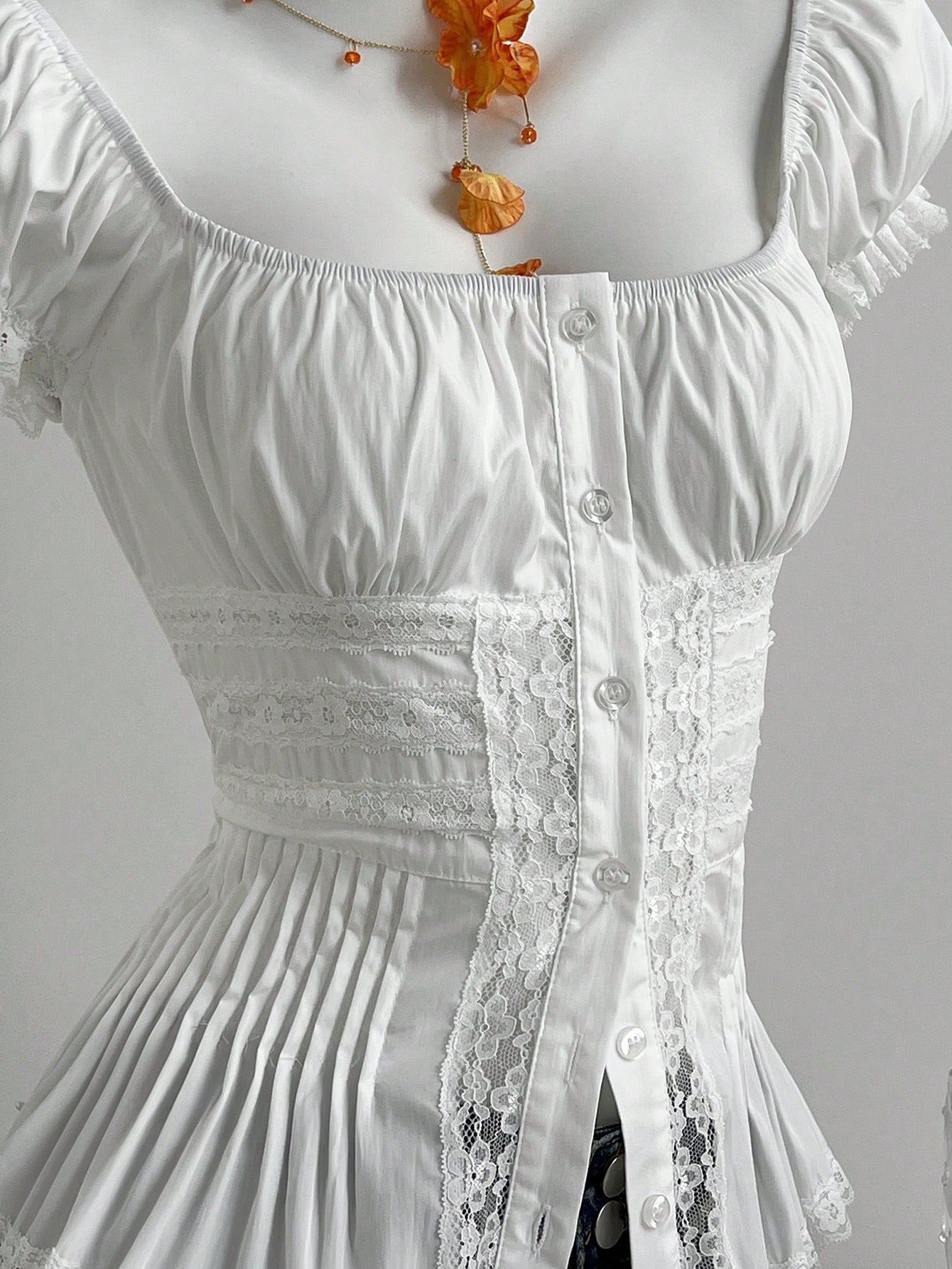 Close up of the waist: openwork lace insertion bands, pintucks, button placket and knife pleated peplum