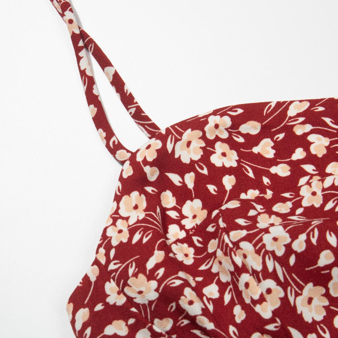 Close view of the cream ditsy floral print on a deep wine red ground