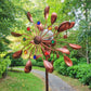 Solar wind spinner stake spinning in the breeze at dusk in the garden