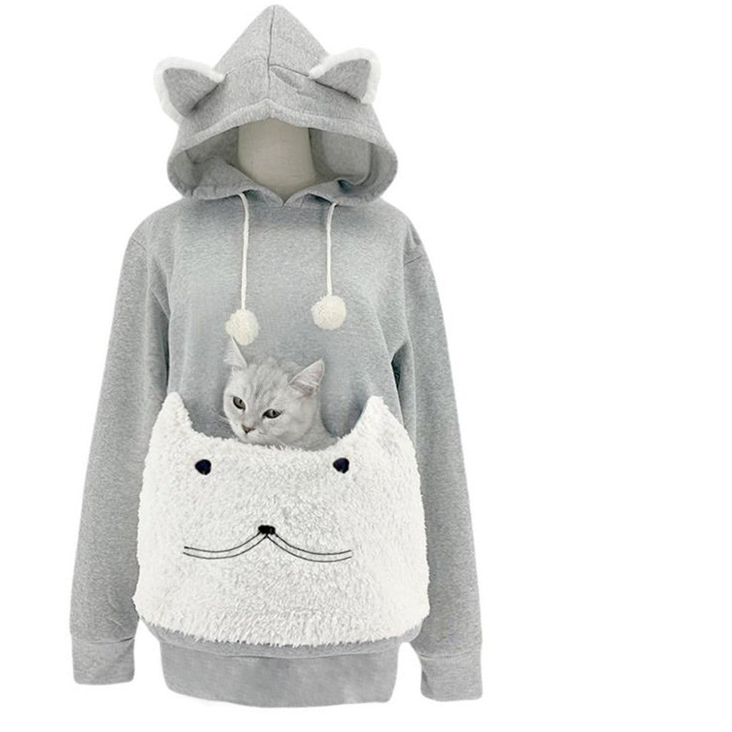 Light gray cat ear hoodie with a white plush cat face pouch holding a small cat and white pompom drawstrings
