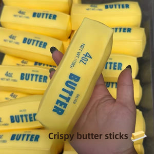 Cream yellow squishy butter stick stress toys printed with a salted butter label held in a hand