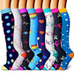 Assorted knee-high compression socks laid out to show the full pattern range