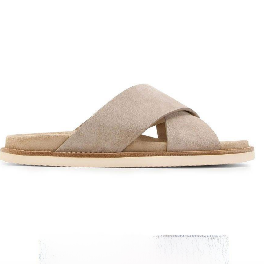 Light taupe suede cross-strap slide sandal in side view with a sand suede footbed and cream sole