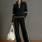 Black sweatshirt and wide leg pants co ord with white side stripes and a drawstring waist