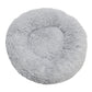 Light gray round plush pet bed with a raised bolster rim on a plain background